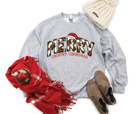 Merry Country Christmas crewneck with brown cow spots in the "Merry" text, perfect for adding a rustic, country-inspired touch to holiday attire.